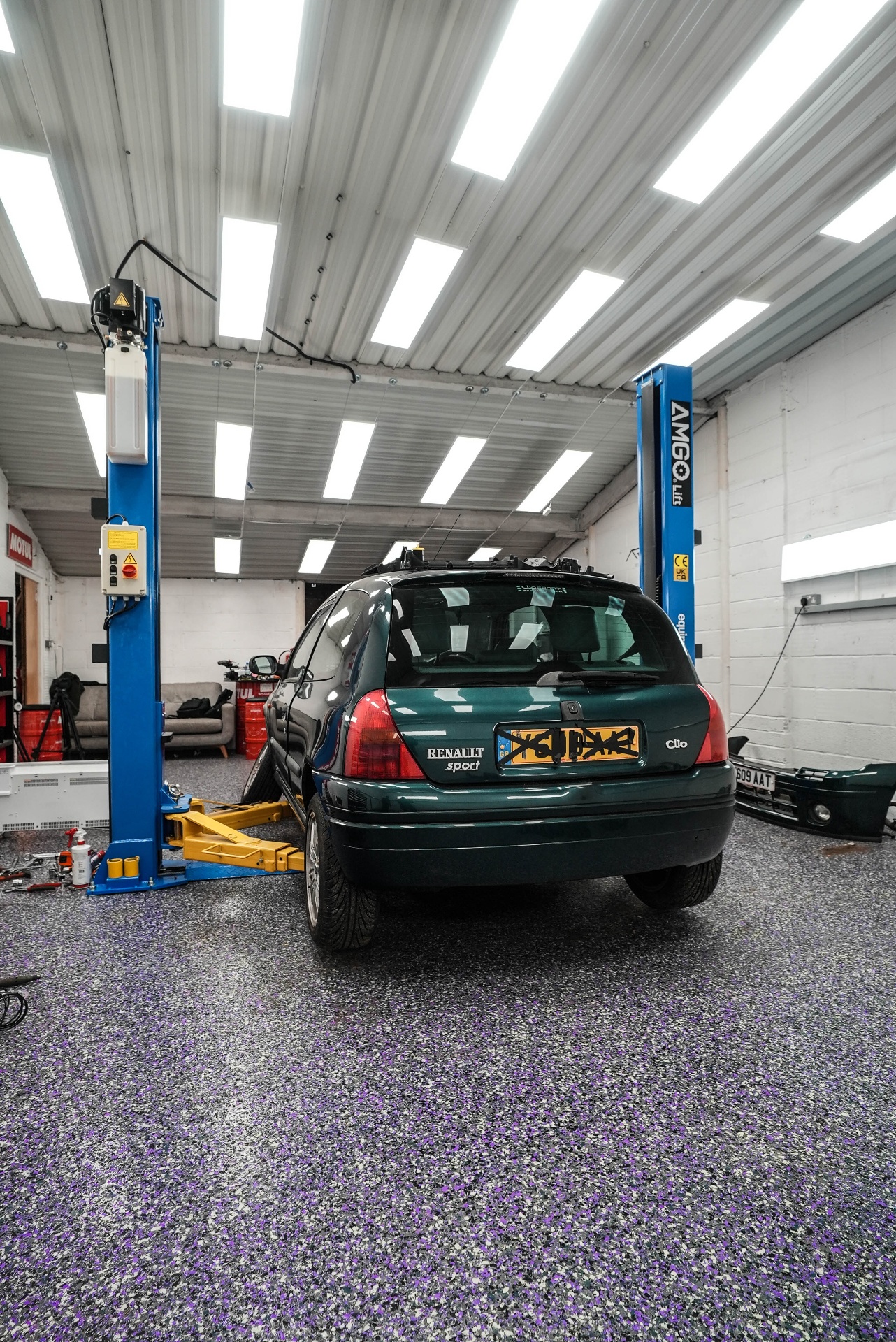 rear view luxury car on flake resin garage floor — premium garage coating