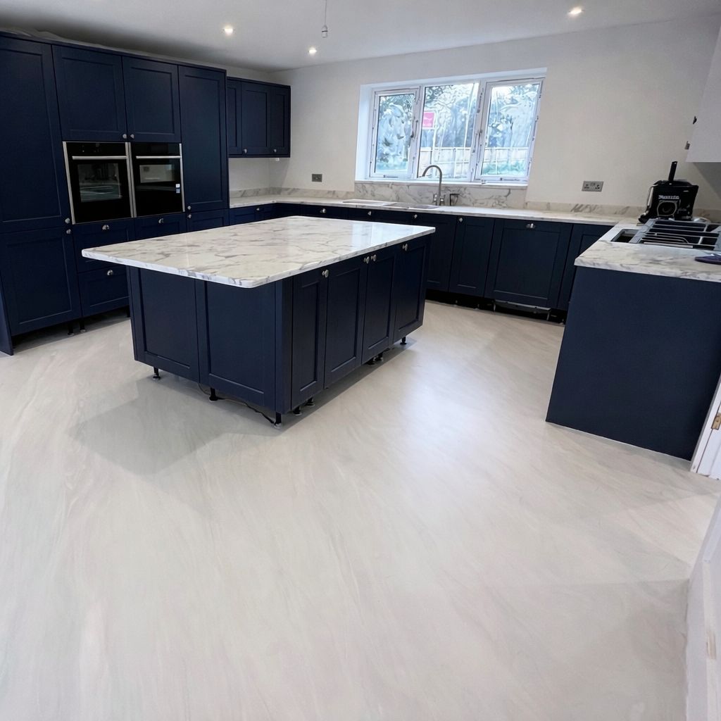 cream pearl PU comfort resin floor beside navy shaker kitchen with marble worktops